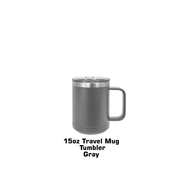 A silver mug sitting on top of a green table.