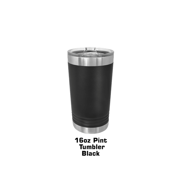 A black and silver cup sitting on top of a green background.