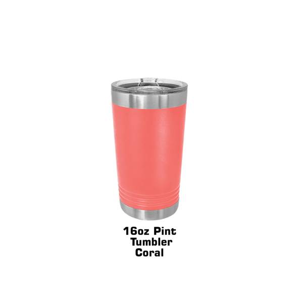 A pink cup is sitting on the ground.