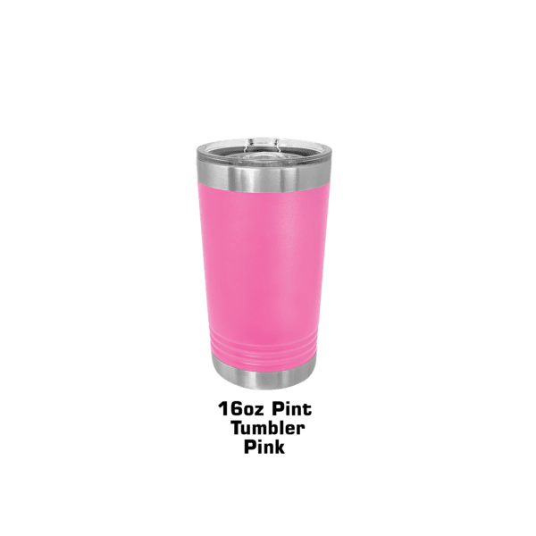 A pink cup is sitting on the ground.