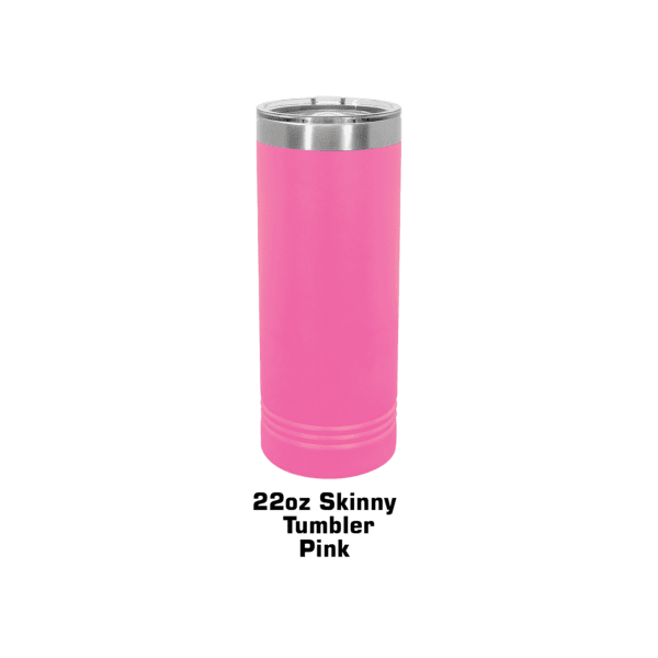 A pink cup is sitting on top of a green table.