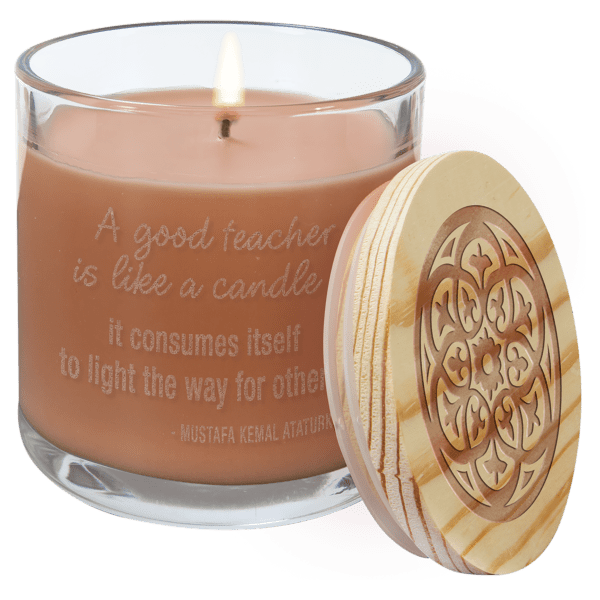 A candle that has been engraved with the words " a good teacher is like a candle ".